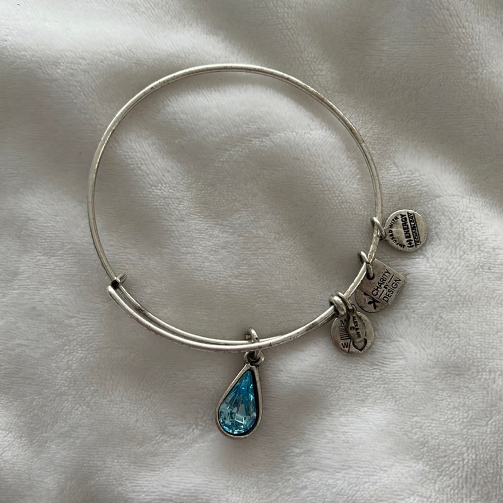 Alex and Ani silver bracelet with blue gem charm